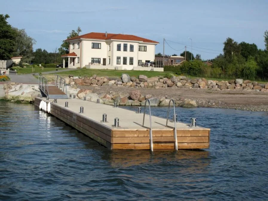Top Marine monolithic dock with pilings, offering a sturdy and secure floating pontoon solution for various marine environments.
